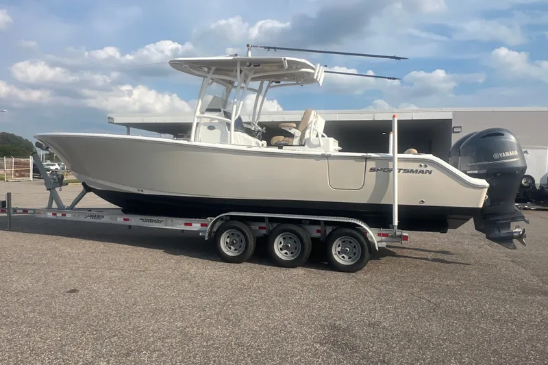Slide: The Image of 2017 Sportsman Open 282 Center Console boat on trailer, parked outdoors. - 18