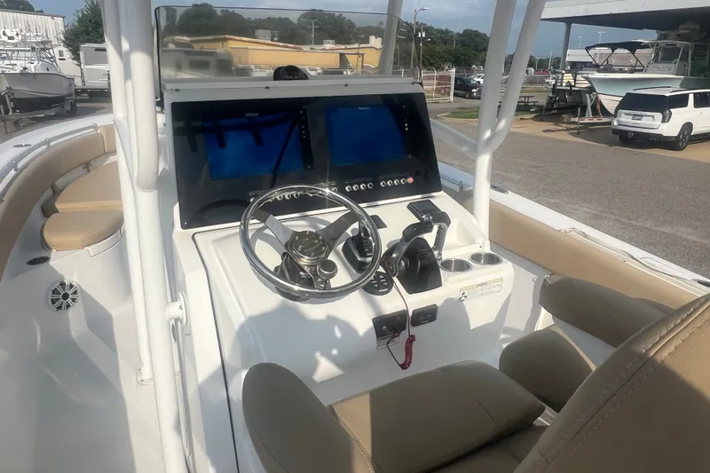 Slide: The Image of 2017 Sportsman Open 282 Center Console boat interior with steering wheel and dual displays. - 19