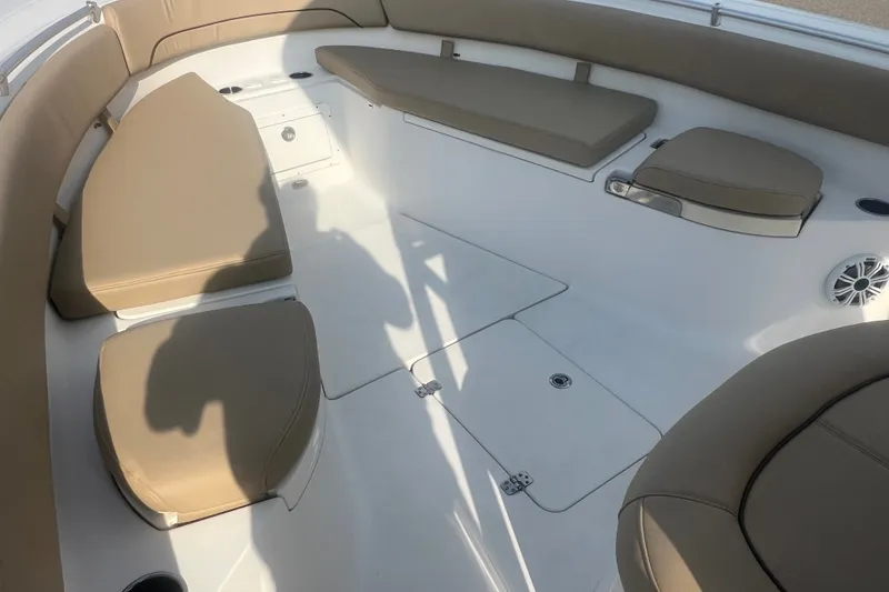 Slide: The Image of 2017 Sportsman Open 282 Center Console boat interior with tan cushioned seating. - 20