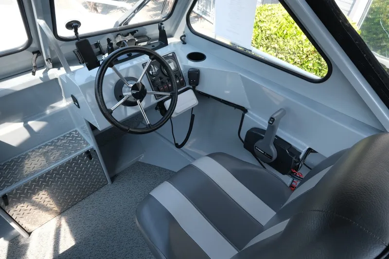 Slide: The Image of 2023 Hewescraft 180 Sportsman boat interior with steering wheel and control panel. - 11