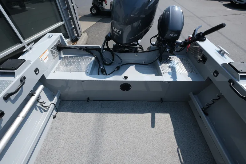 Slide: The Image of 2023 Hewescraft 180 Sportsman boat interior with dual outboard motors. - 13