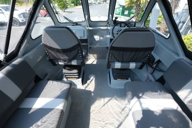 Slide: The Image of Interior of 2023 Hewescraft 180 Sportsman boat with seating and steering console. - 10