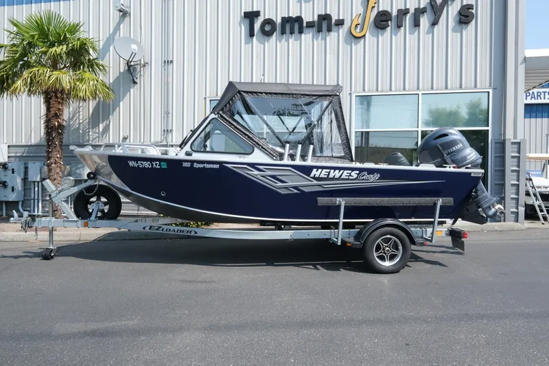 Slide: The Image of 2023 Hewescraft 180 Sportsman boat on trailer outside dealership. - 2