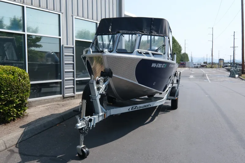 Slide: The Image of 2023 Hewescraft 180 Sportsman boat on trailer, parked outside a building. - 3