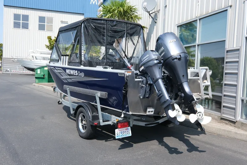Slide: The Image of 2023 Hewescraft 180 Sportsman boat with dual Yamaha outboard motors on a trailer. - 4