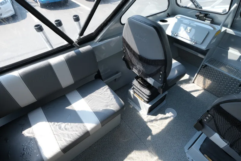 Slide: The Image of Interior of 2023 Hewescraft 180 Sportsman boat with seating and dashboard. - 9