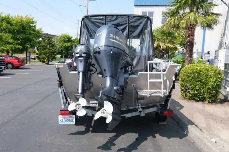 Slide: The Image of 2023 Hewescraft 180 Sportsman boat with Yamaha outboard motors in a parking lot. - 5