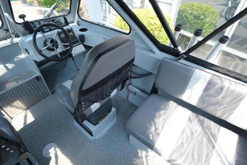 Slide: The Image of Interior of 2023 Hewescraft 180 Sportsman boat with steering wheel and seating. - 12
