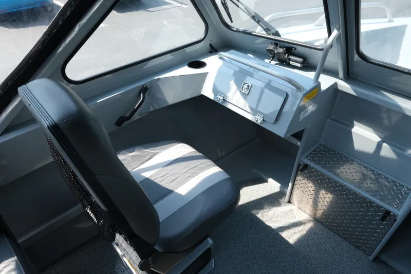 Slide: The Image of Interior of 2023 Hewescraft 180 Sportsman boat, featuring seating and control panel. - 7