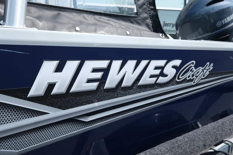 Slide: The Image of 2023 Hewescraft 180 Sportsman boat with Yamaha motor, close-up of logo and design. - 16
