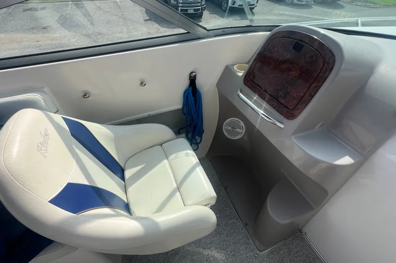 Slide: The Image of Interior of a 2004 Rinker 282 Captiva Bowrider with white and blue seating. - 19