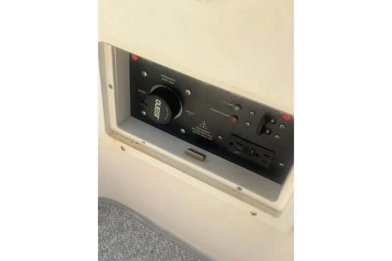 Slide: The Image of Control panel of a 2004 Rinker 282 Captiva Bowrider boat, featuring battery and power switches. - 53