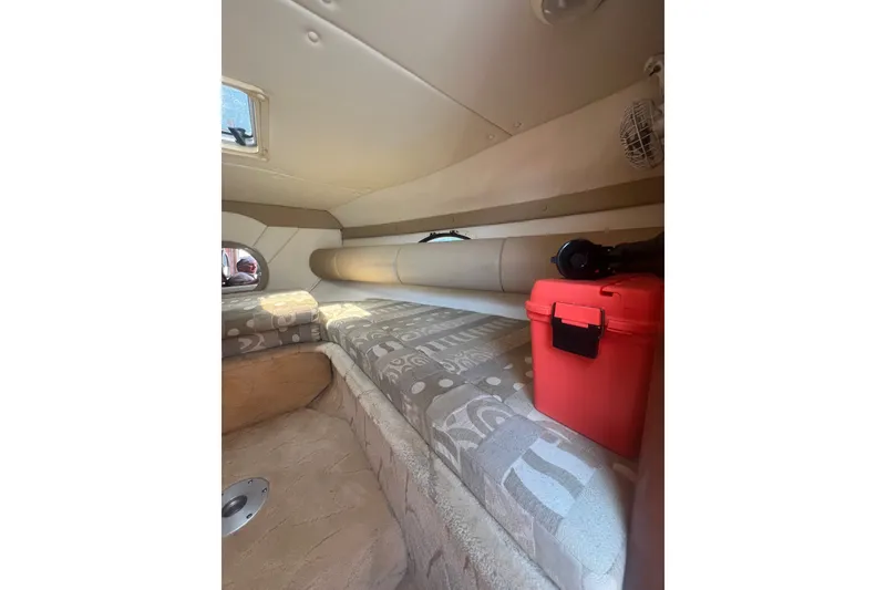 Slide: The Image of Interior cabin of 2004 Rinker 282 Captiva Bowrider with patterned seating and red storage box. - 48