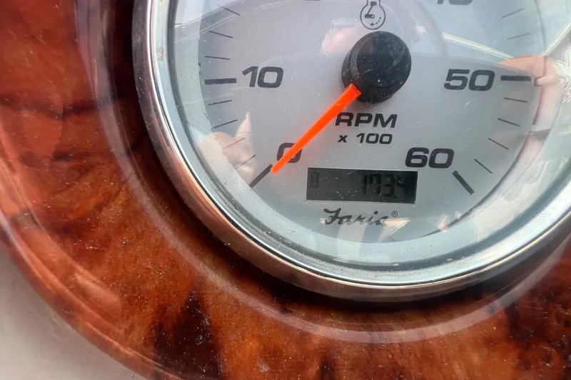 Slide: The Image of Close-up of a 2004 Rinker 282 Captiva Bowrider RPM gauge displaying 1034 hours. - 20