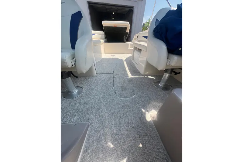 Slide: The Image of 2004 Rinker 282 Captiva Bowrider interior with seating and carpeted floor. - 49