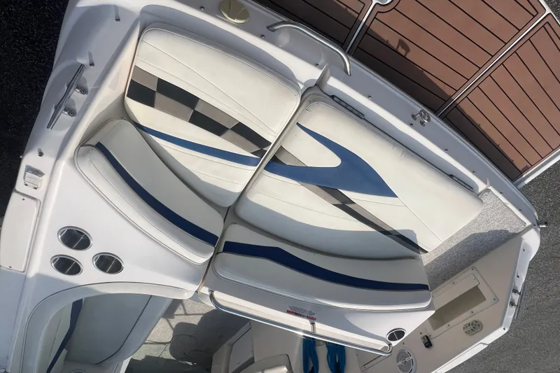 Slide: The Image of 2004 Rinker 282 Captiva Bowrider interior with white and blue seating. - 15