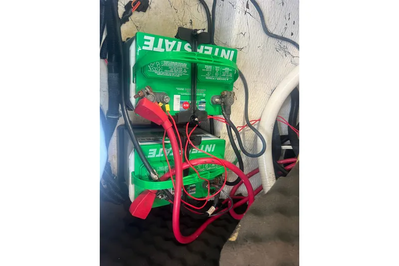 Slide: The Image of Battery setup in a 2004 Rinker 282 Captiva Bowrider boat, featuring Interstate batteries. - 36