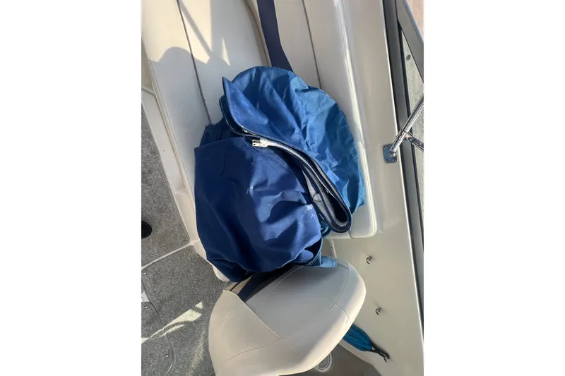 Slide: The Image of Blue cover on seat of 2004 Rinker 282 Captiva Bowrider boat interior. - 33