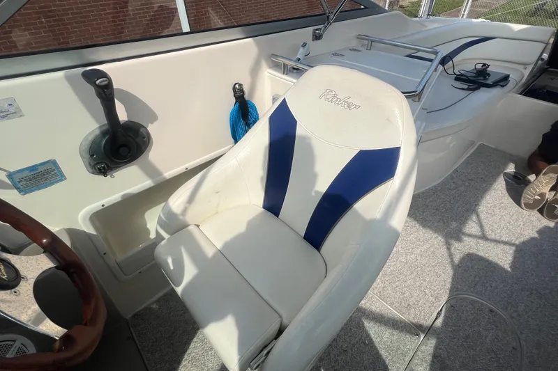 Slide: The Image of 2004 Rinker 282 Captiva Bowrider interior with white and blue seating. - 30