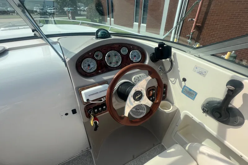 Slide: The Image of 2004 Rinker 282 Captiva Bowrider dashboard with steering wheel and instrument panel. - 18