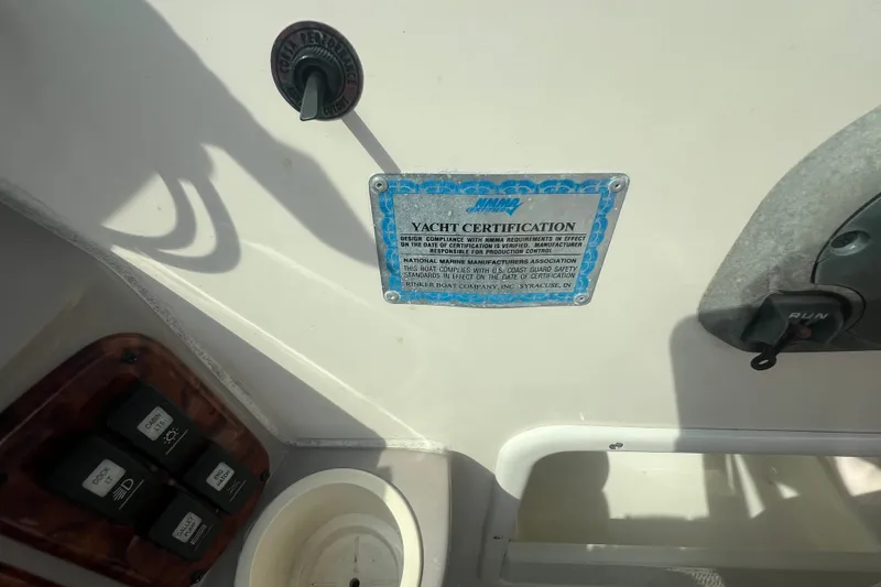 Slide: The Image of 2004 Rinker 282 Captiva Bowrider yacht certification plaque and control panel. - 31