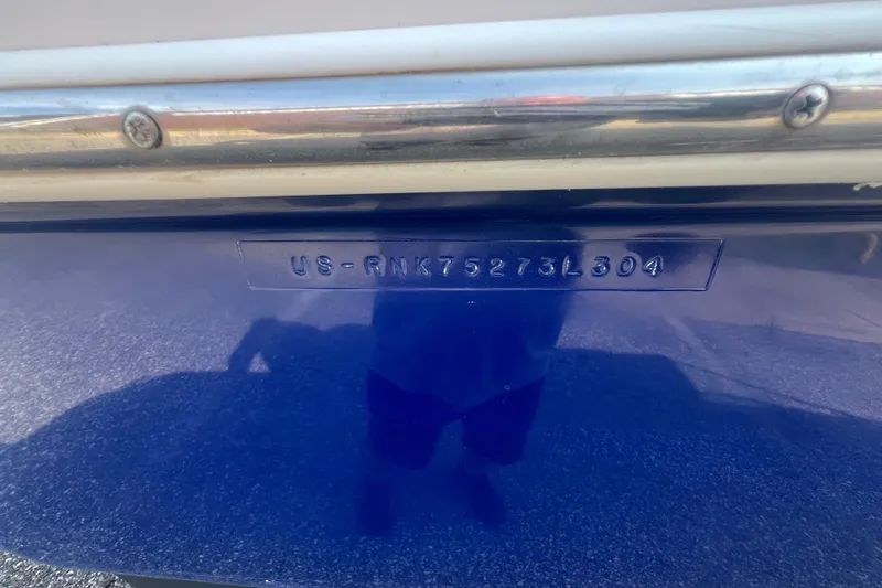 Slide: The Image of 2004 Rinker 282 Captiva Bowrider hull identification number on blue surface. - 39