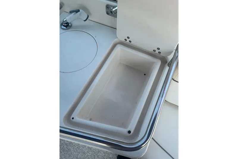 Slide: The Image of Storage compartment on a 2004 Rinker 282 Captiva Bowrider boat. - 40