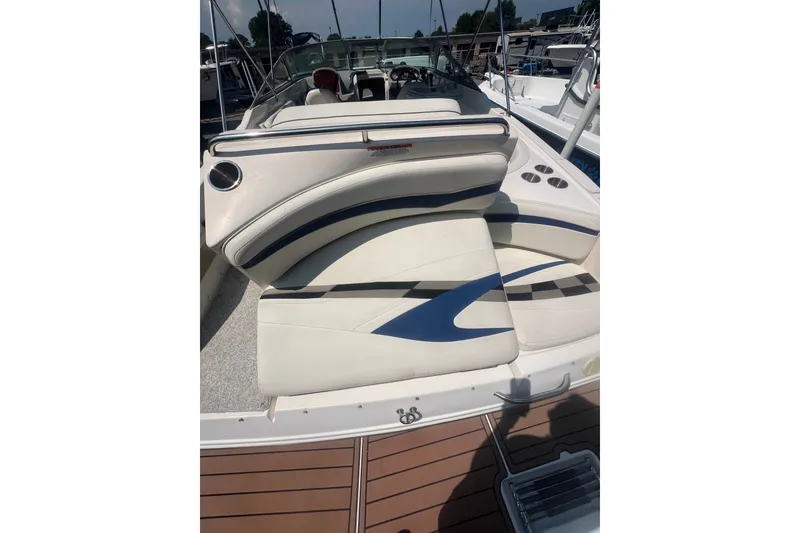 Slide: The Image of 2004 Rinker 282 Captiva Bowrider with white and blue seating, docked at marina. - 55
