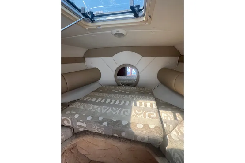 Slide: The Image of Interior cabin of a 2004 Rinker 282 Captiva Bowrider with patterned cushions. - 47