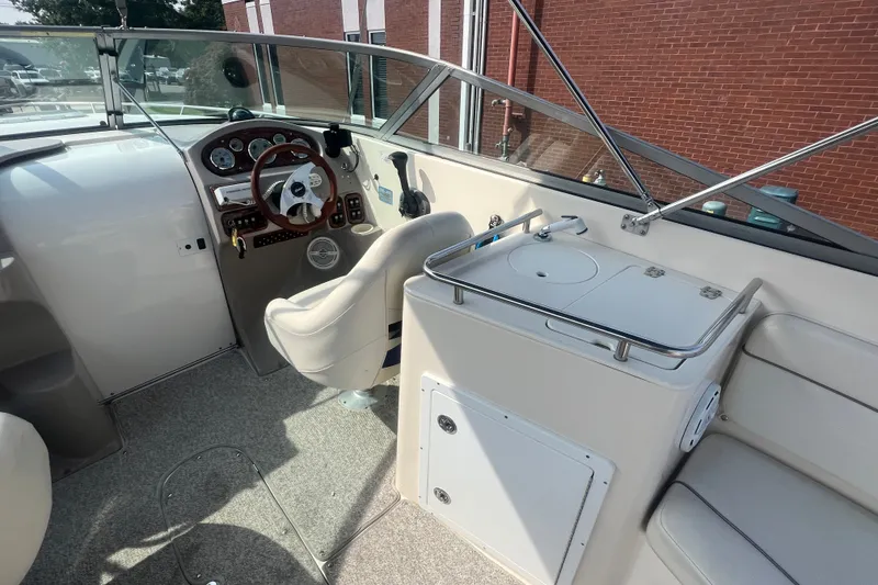 Slide: The Image of 2004 Rinker 282 Captiva Bowrider cockpit with steering wheel and seating area. - 17