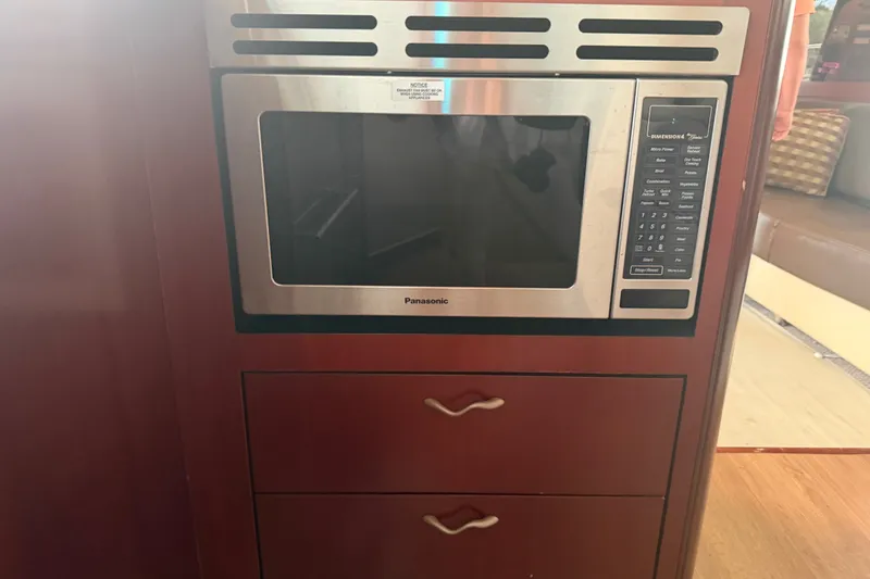Slide: The Image of Built-in Panasonic microwave in 2006 Sea Ray 550 Sedan Bridge yacht kitchen. - 73