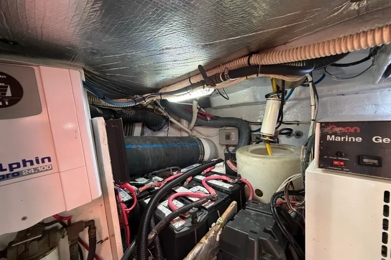 Slide: The Image of Engine room of a 2006 Sea Ray 550 Sedan Bridge with marine generator and wiring. - 142