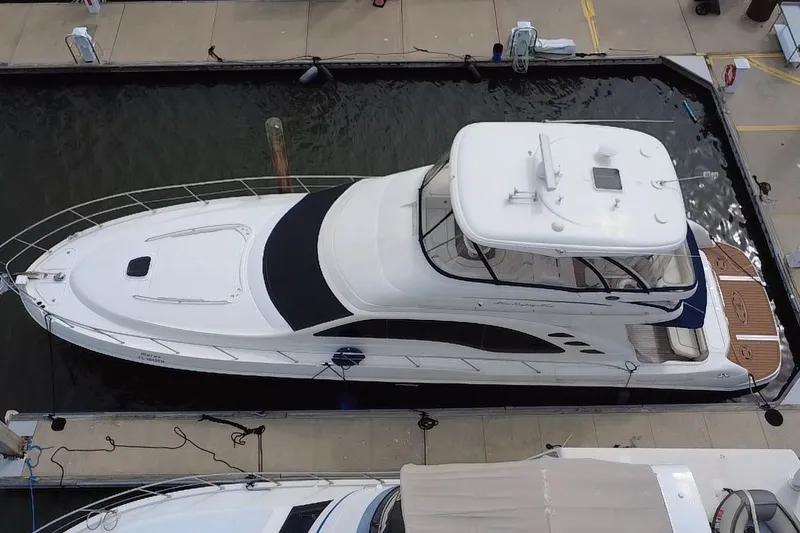 Slide: The Image of 2006 Sea Ray 550 Sedan Bridge yacht docked at marina, aerial view. - 12