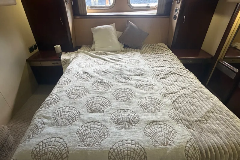 Slide: The Image of Luxurious bedroom interior of 2006 Sea Ray 550 Sedan Bridge yacht with cozy bedding. - 78