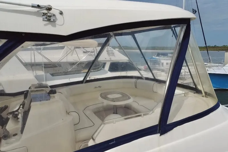 Slide: The Image of 2006 Sea Ray 550 Sedan Bridge cockpit with clear enclosure and seating area. - 18