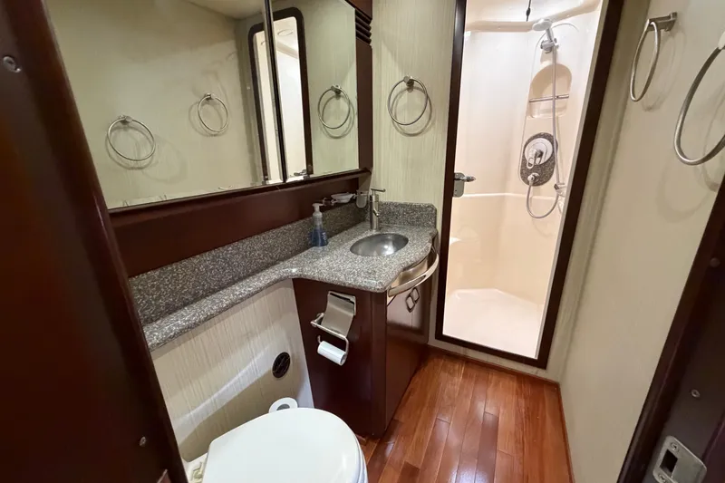 Slide: The Image of Luxurious bathroom in 2006 Sea Ray 550 Sedan Bridge yacht with shower and granite countertop. - 120