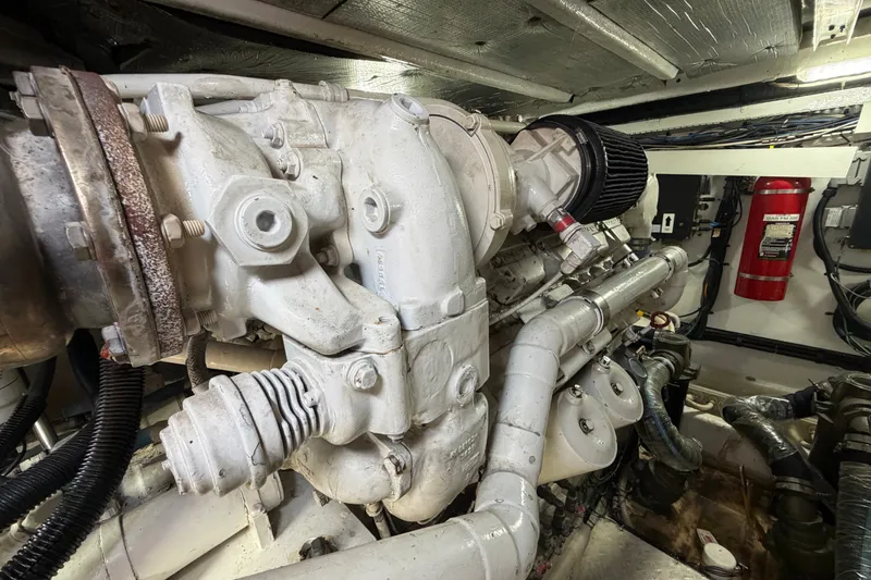 Slide: The Image of Engine room of a 2006 Sea Ray 550 Sedan Bridge yacht, featuring mechanical components. - 144