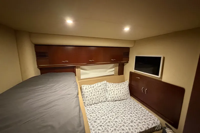 Slide: The Image of Luxurious cabin interior of 2006 Sea Ray 550 Sedan Bridge yacht with cozy bedding. - 127
