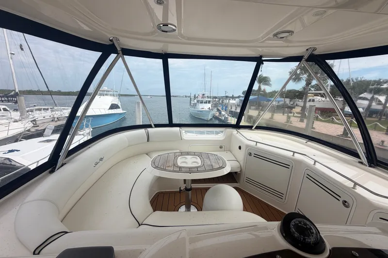 Slide: The Image of Interior view of 2006 Sea Ray 550 Sedan Bridge yacht with marina backdrop. - 52