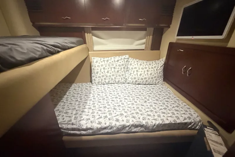 Slide: The Image of Cozy cabin interior of 2006 Sea Ray 550 Sedan Bridge with bunk beds and TV. - 97