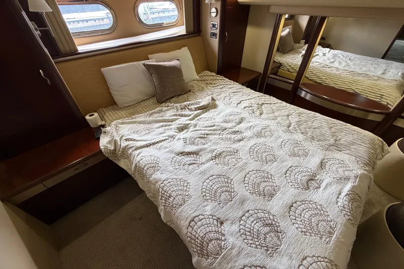 Slide: The Image of Luxurious bedroom interior of 2006 Sea Ray 550 Sedan Bridge yacht with cozy bedding. - 122