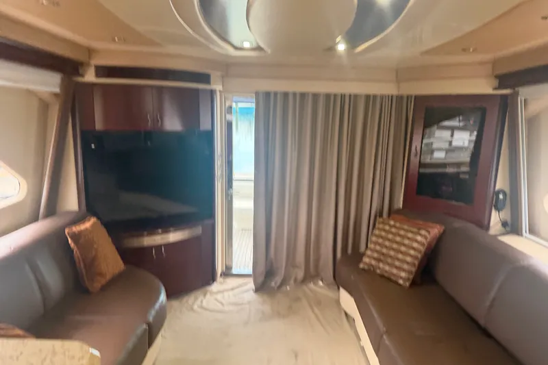 Slide: The Image of Interior of 2006 Sea Ray 550 Sedan Bridge yacht with luxurious seating and entertainment area. - 63