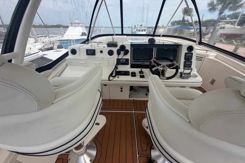 Slide: The Image of Luxurious 2006 Sea Ray 550 Sedan Bridge helm with dual seats and advanced navigation systems. - 50