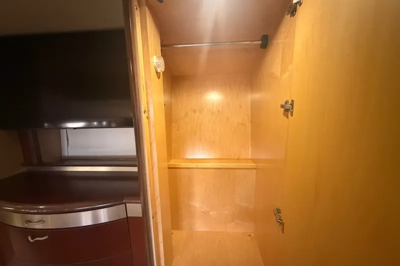 Slide: The Image of Wooden closet interior on a 2006 Sea Ray 550 Sedan Bridge yacht. - 89