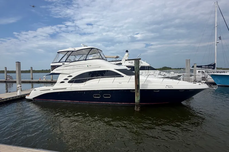 Slide: The Image of 2006 Sea Ray 550 Sedan Bridge yacht docked at marina under cloudy sky. - 37
