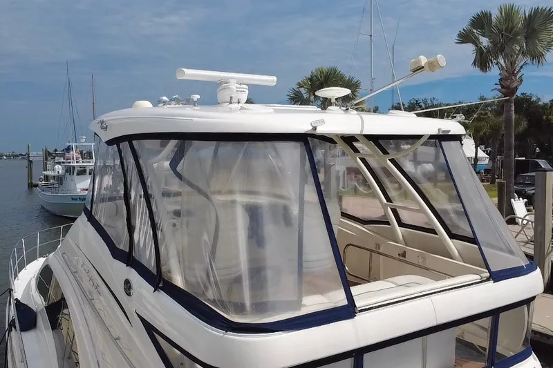 Slide: The Image of 2006 Sea Ray 550 Sedan Bridge yacht docked at marina with clear enclosure. - 22