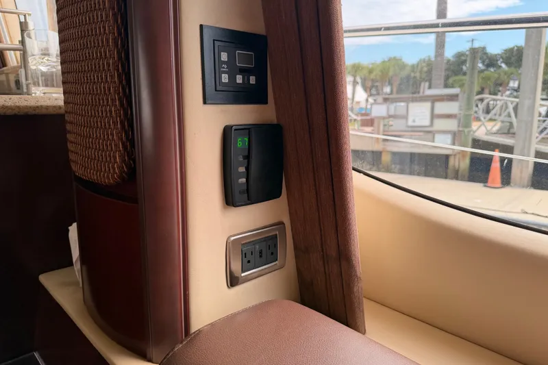 Slide: The Image of Interior view of a 2006 Sea Ray 550 Sedan Bridge yacht with control panel and window. - 108