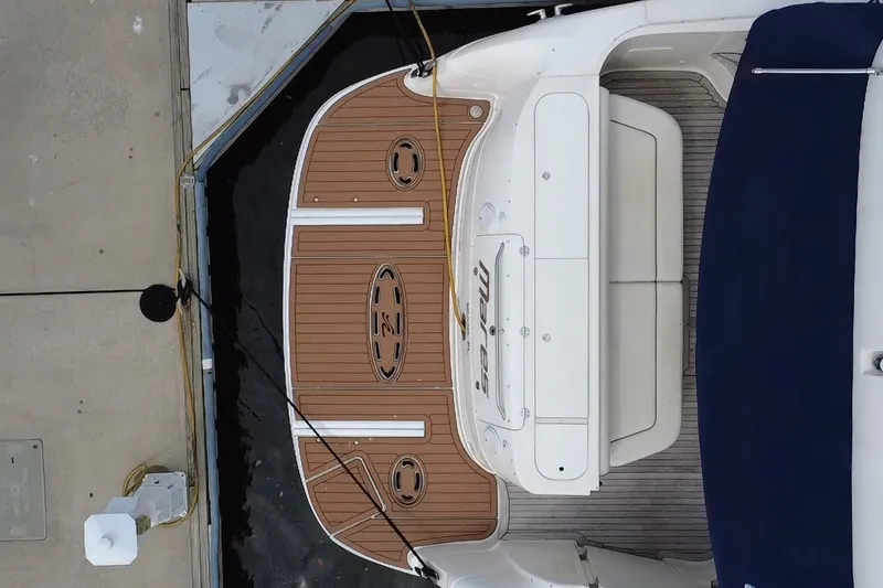 Slide: The Image of Overhead view of 2006 Sea Ray 550 Sedan Bridge docked, showcasing teak swim platform. - 11