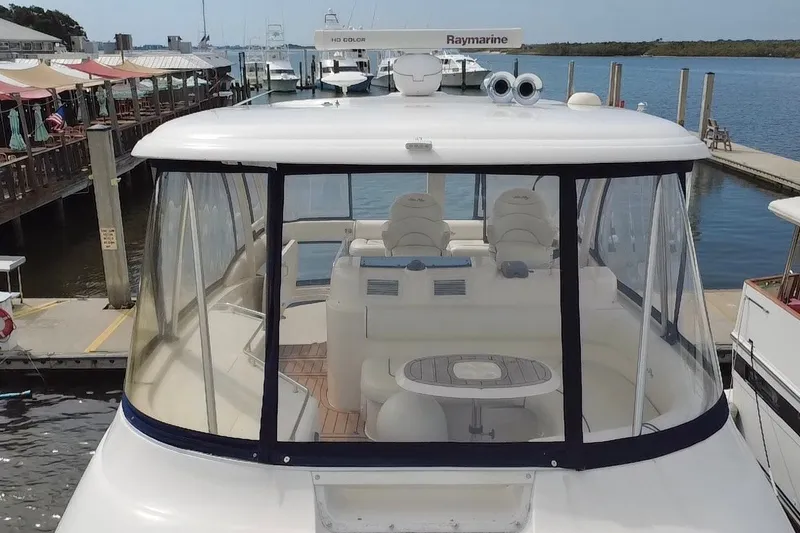 Slide: The Image of 2006 Sea Ray 550 Sedan Bridge yacht docked at marina, featuring enclosed flybridge. - 16
