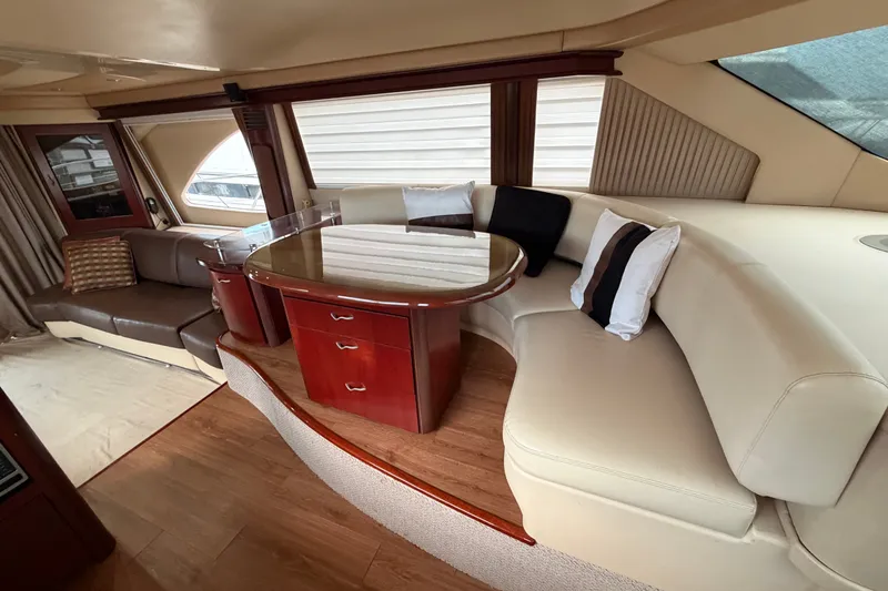 Slide: The Image of Luxurious interior of a 2006 Sea Ray 550 Sedan Bridge yacht with elegant seating and table. - 112